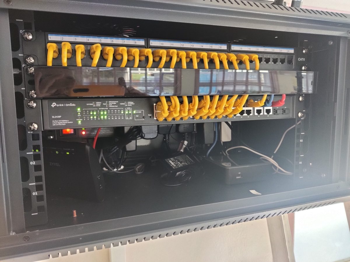 Managed business network cabinet with structured cabling